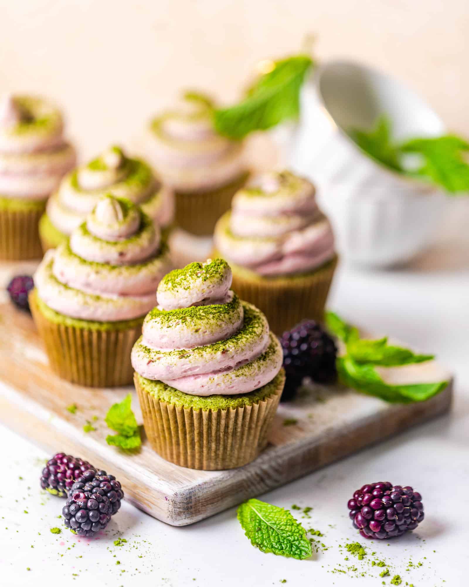cupcakes on a table with berries