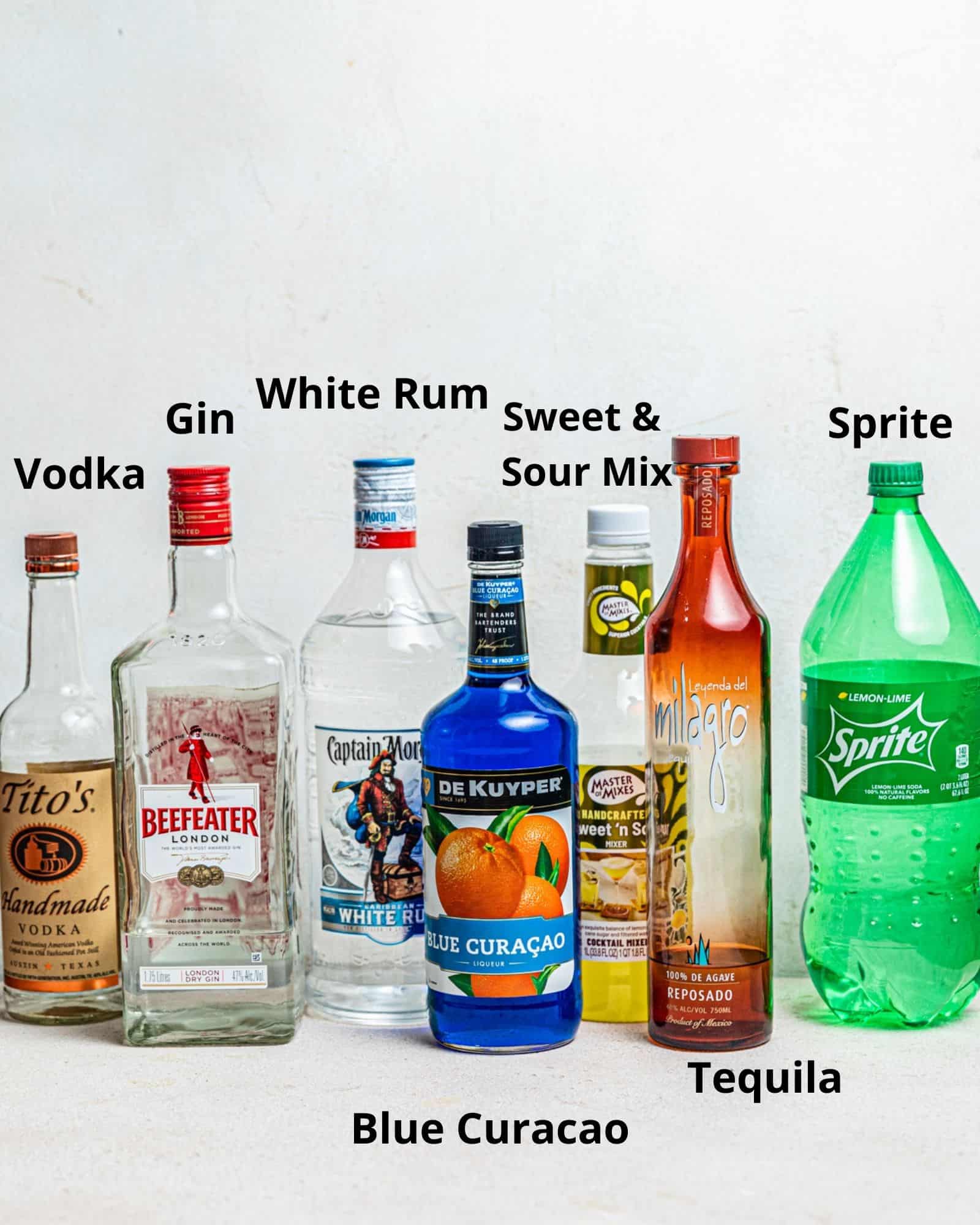 the ingredients needed to make an AMF drink - vodka, gin, white rum, blue curacao, tequila, sweet and sour mix, and lemon lime soda.