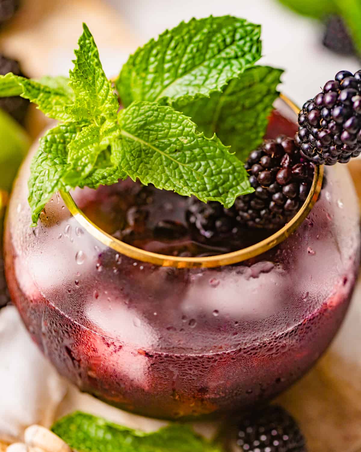 an up close photo of a glass of blackberry mojito