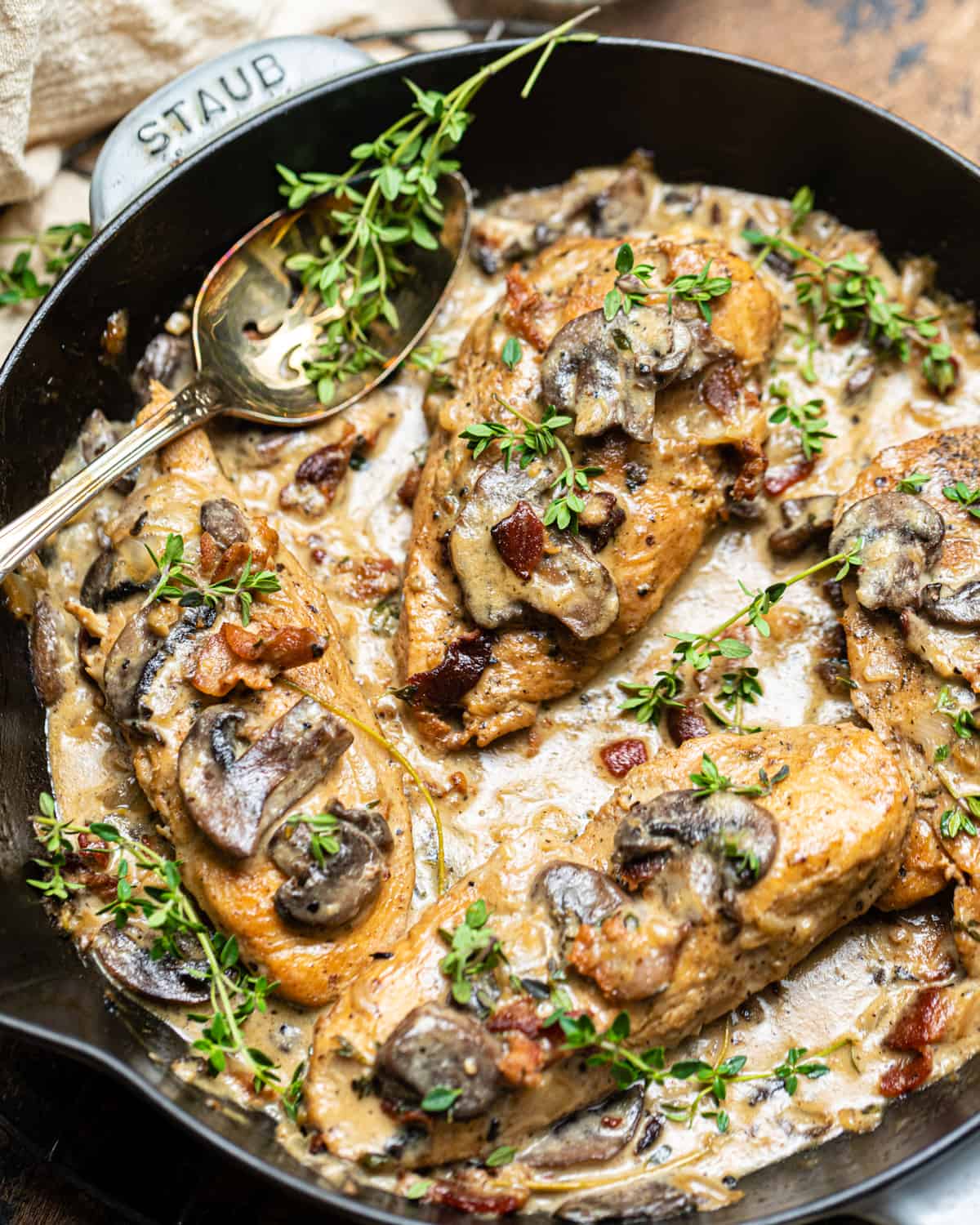 creamy mushroom chicken in a skillet with a spoon.