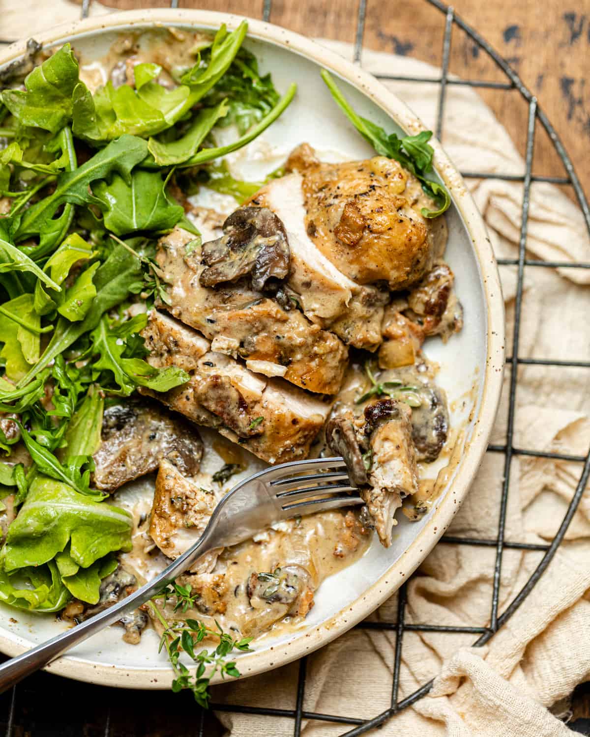 chicken and mushrooms on a plate with arugula.