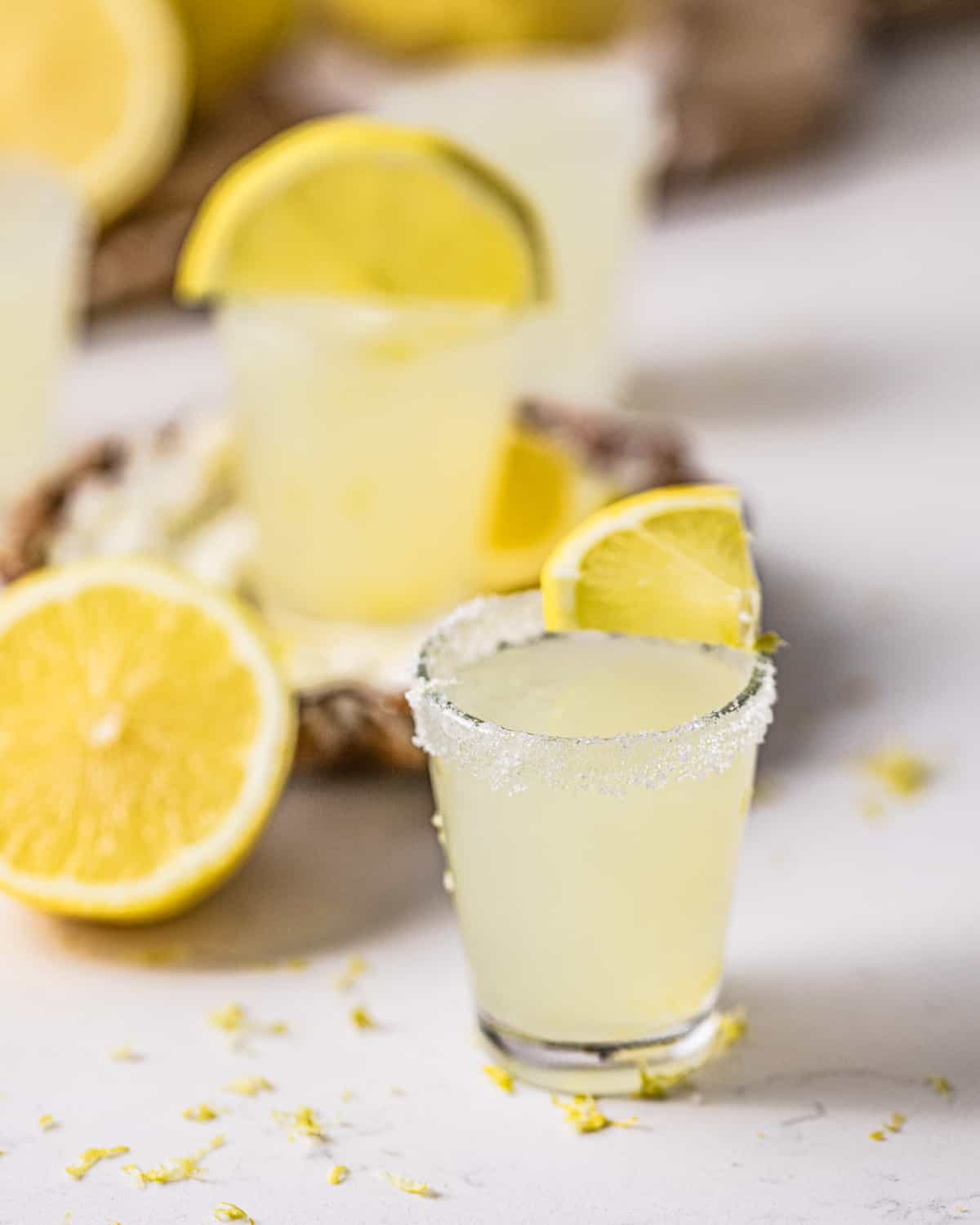 lemon drop shots on a white table.
