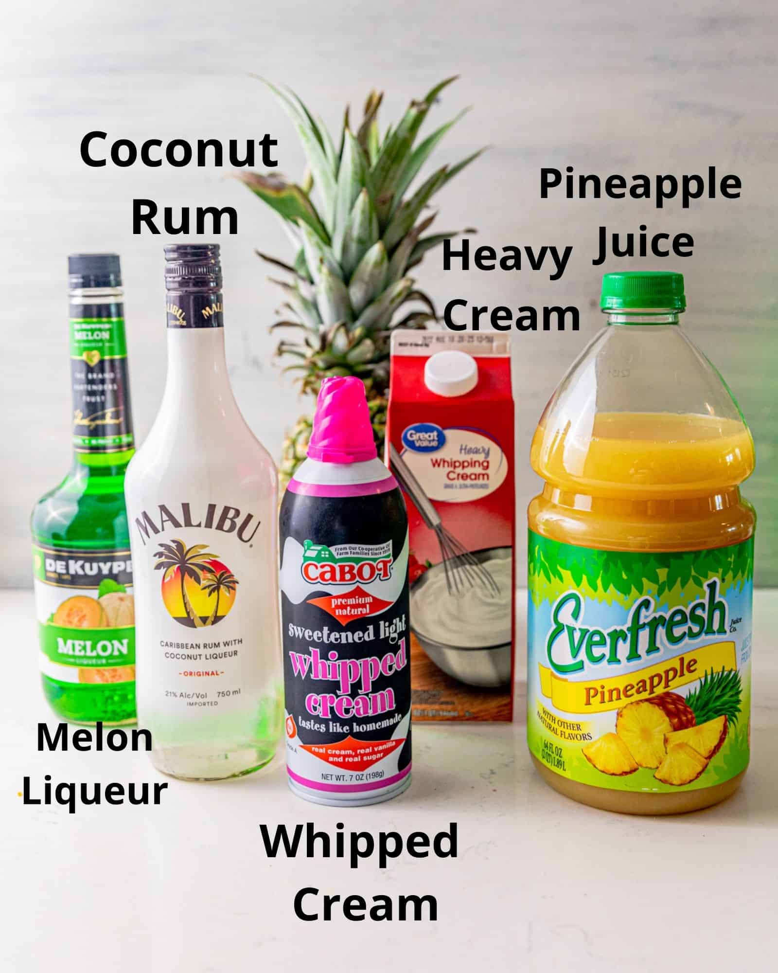 the ingredients to make a scooby snack shot - coconut rum, melon liqueur, heavy cream, pineapple juice, whipped cream.