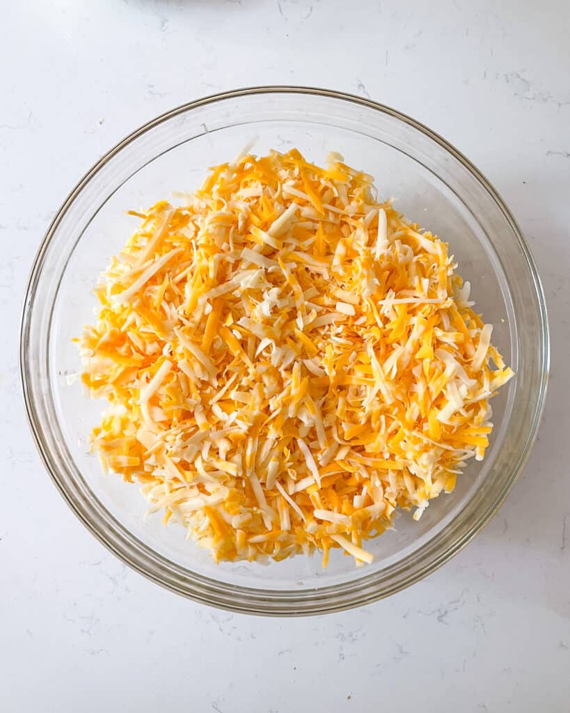shredded cheeses mixed together in bowl.