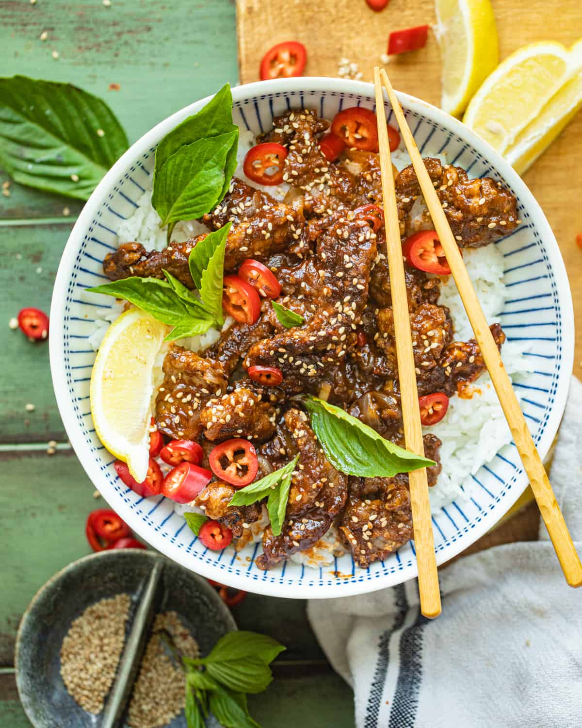Crispy Chilli Beef in a serving bowl with chopsticks.