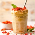 edible sugar cookie dough in a jar with strawberry crumbles on top.