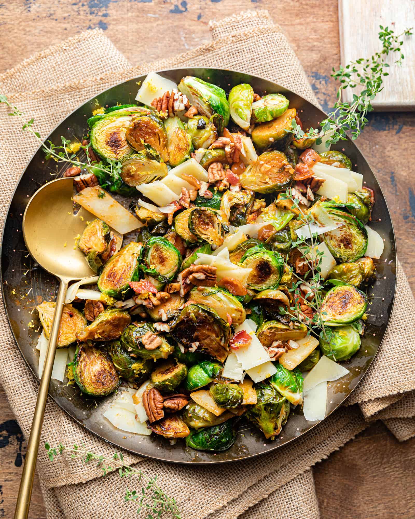 roasted brussels sprouts in a bowl with a serving spoon.