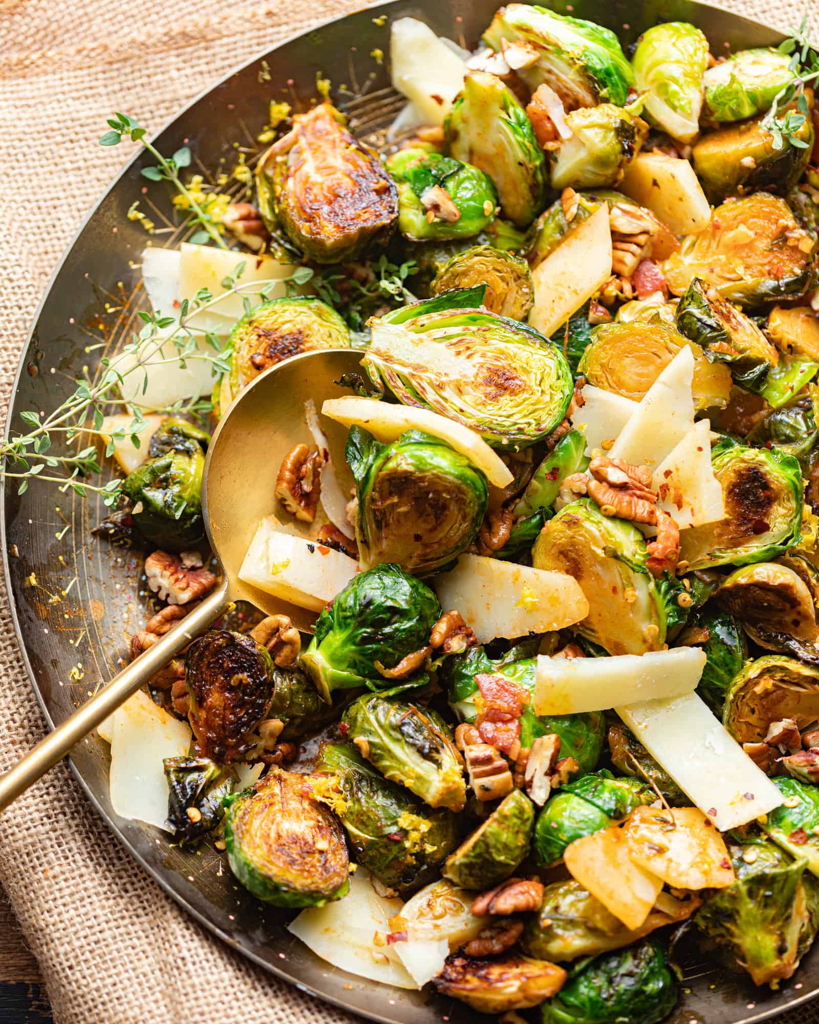 honey sriracha brussels sprouts in a gold serving bowl.