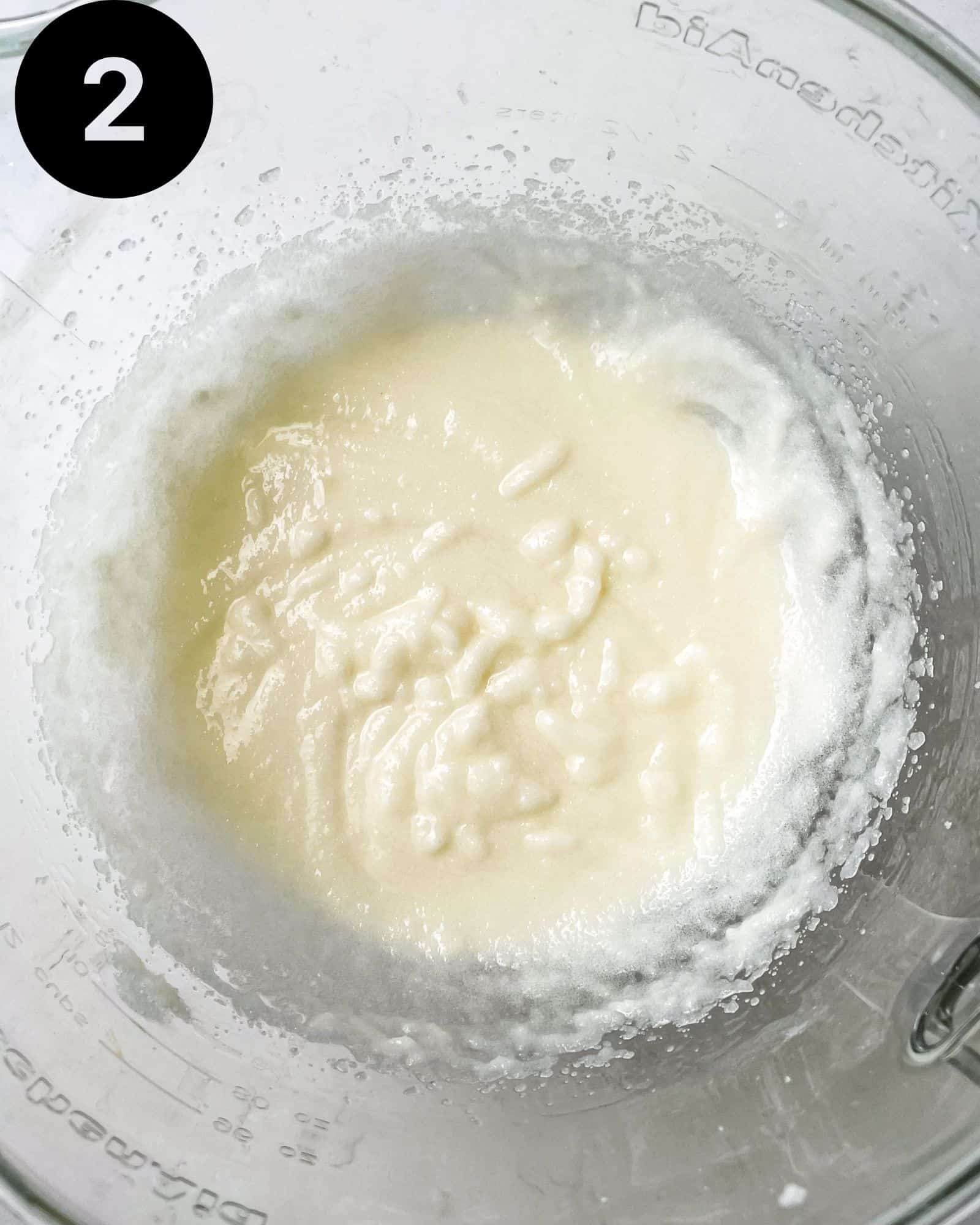 butter, vegetable oil, and sugar whisked together in a bowl.