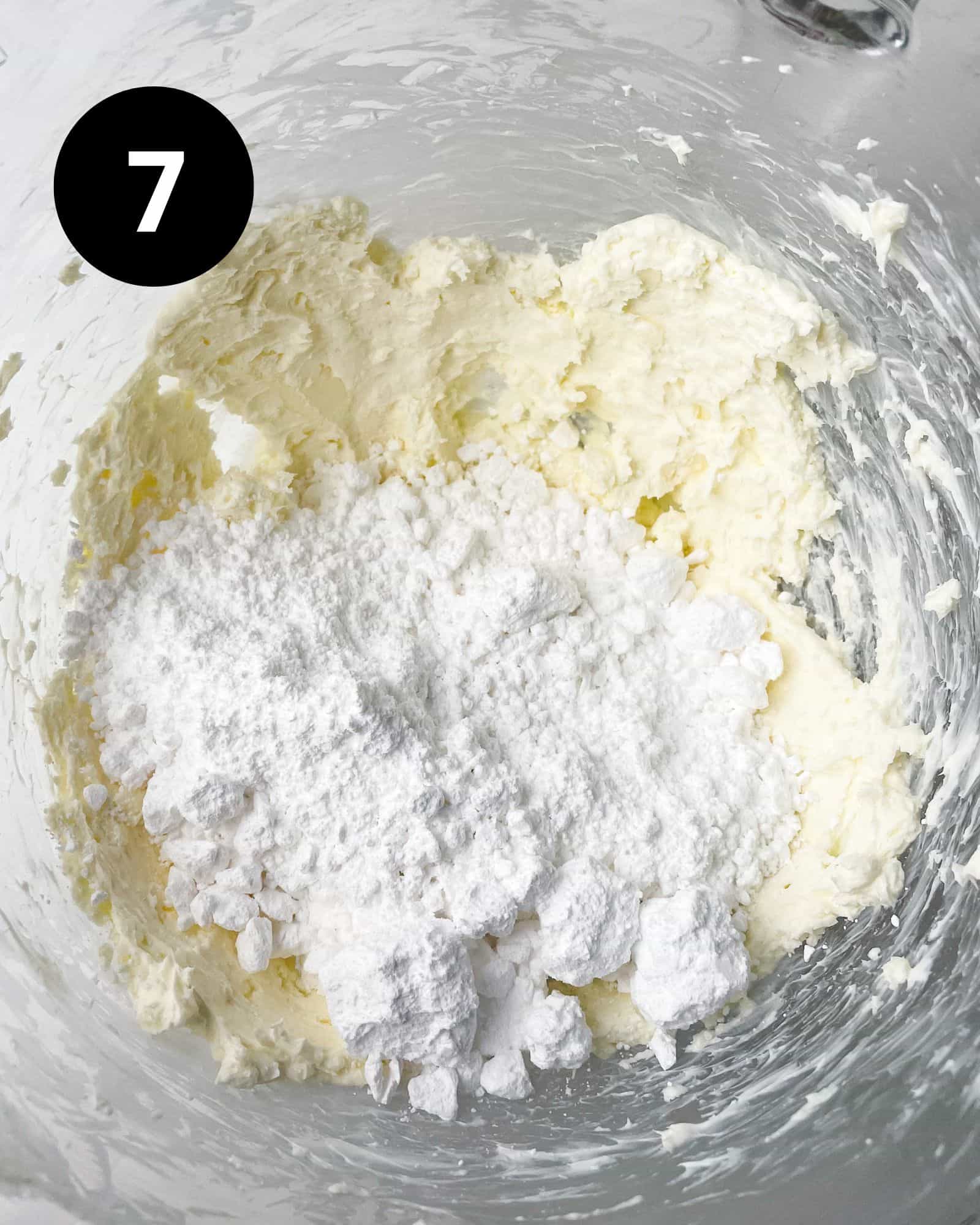 butter, cream cheese, and powdered sugar mixed together in a bowl.