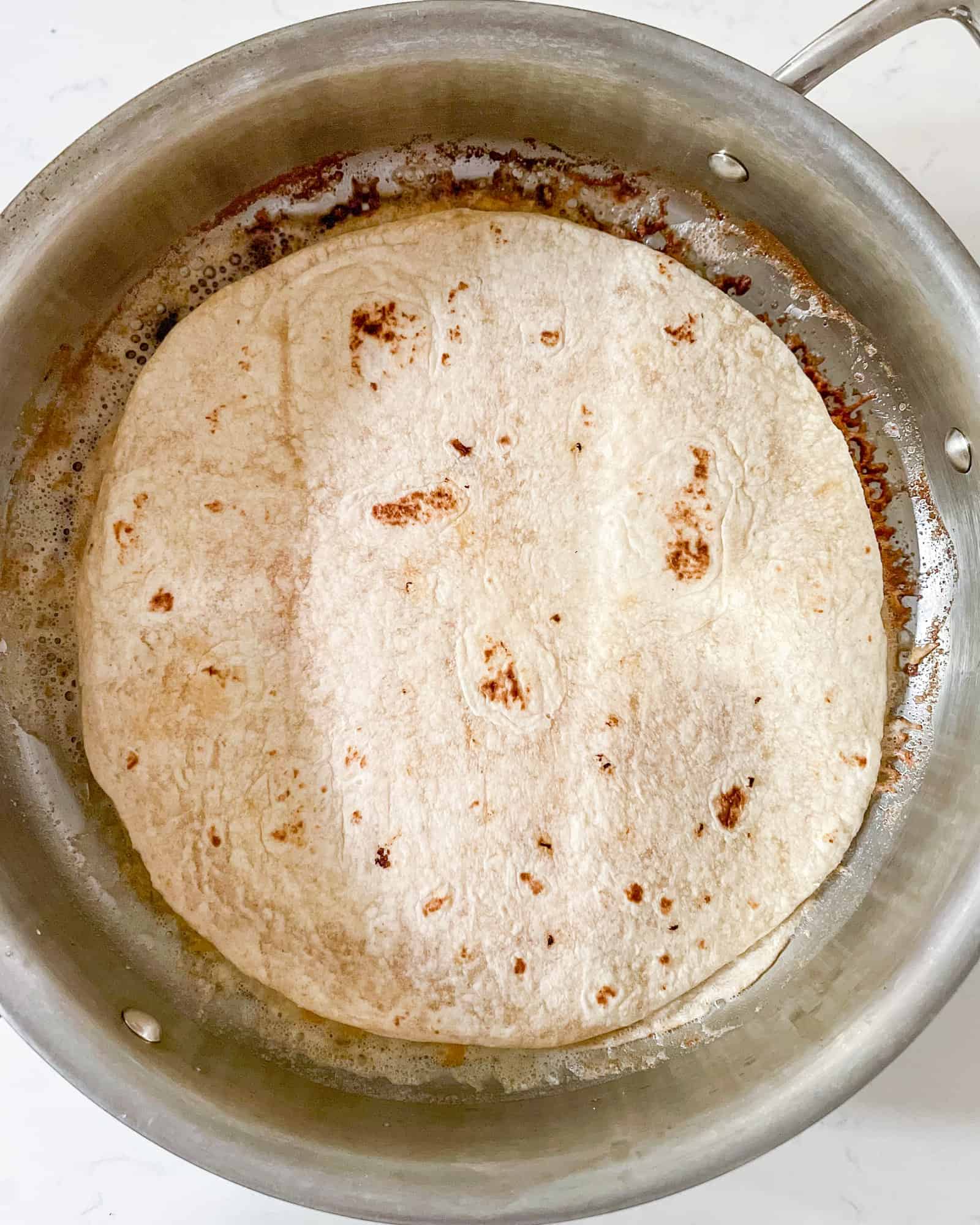 cheese quesadilla in a frying pan.
