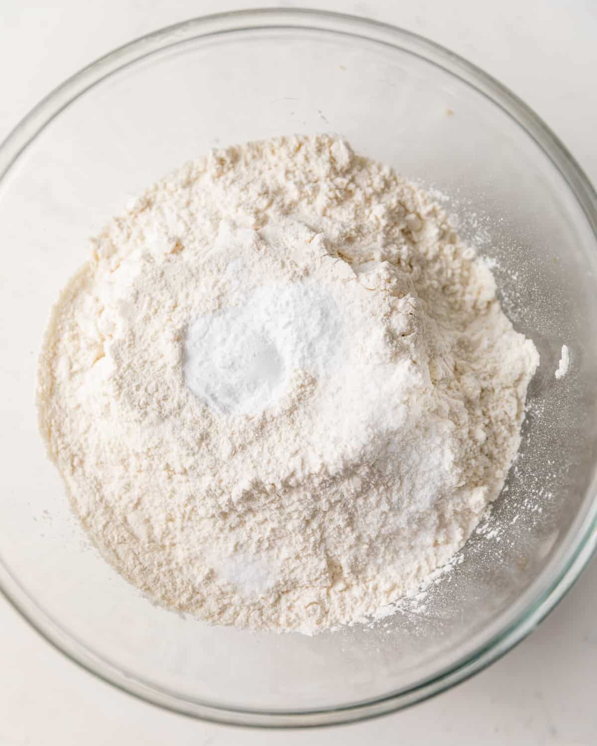 the dry ingredients in a mixing bowl - all purpose flour, baking soda, baking powder, and salt.
