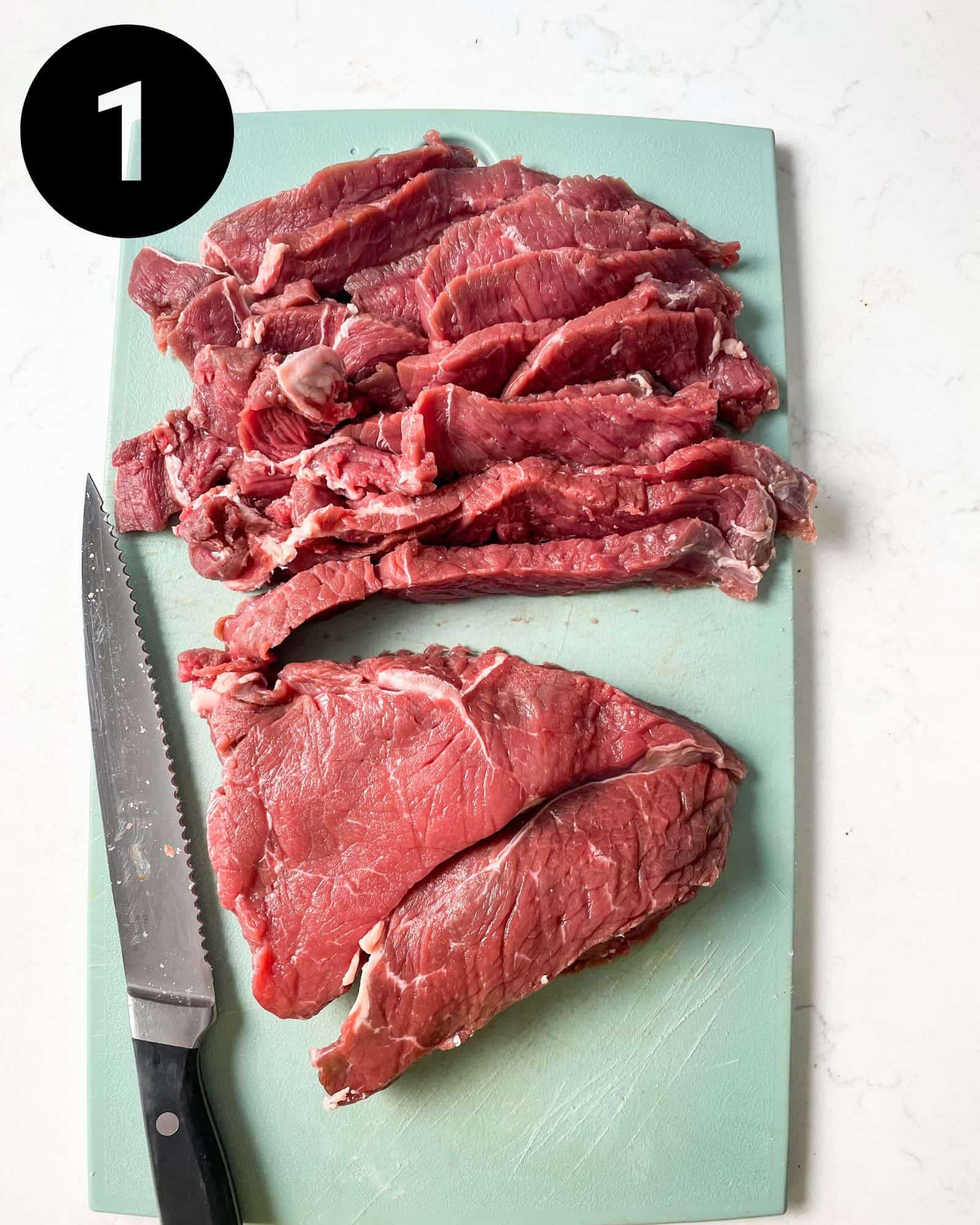 sliced sirloin steak on a cutting board.
