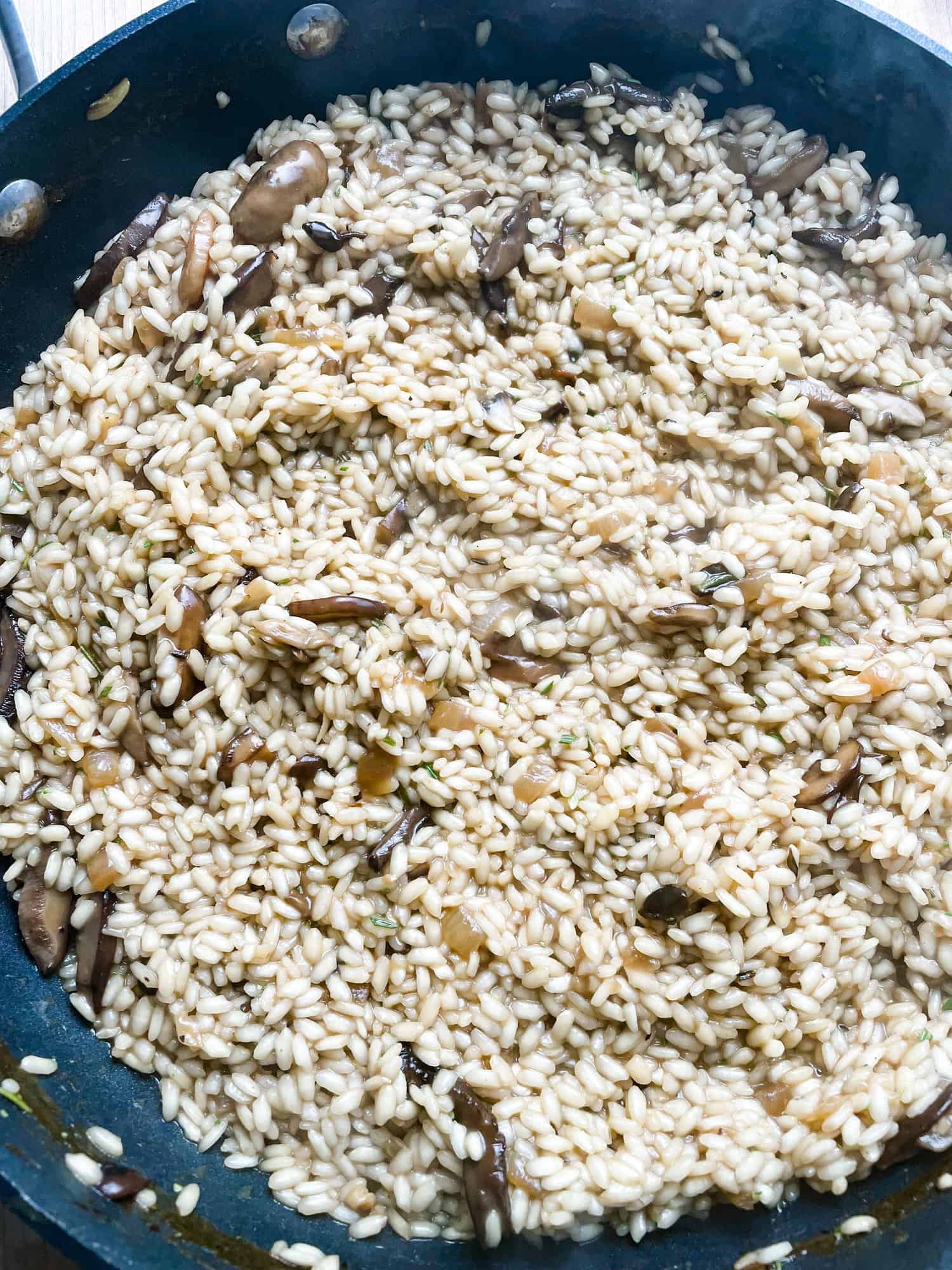 risotto in a pan with onions and garlic.
