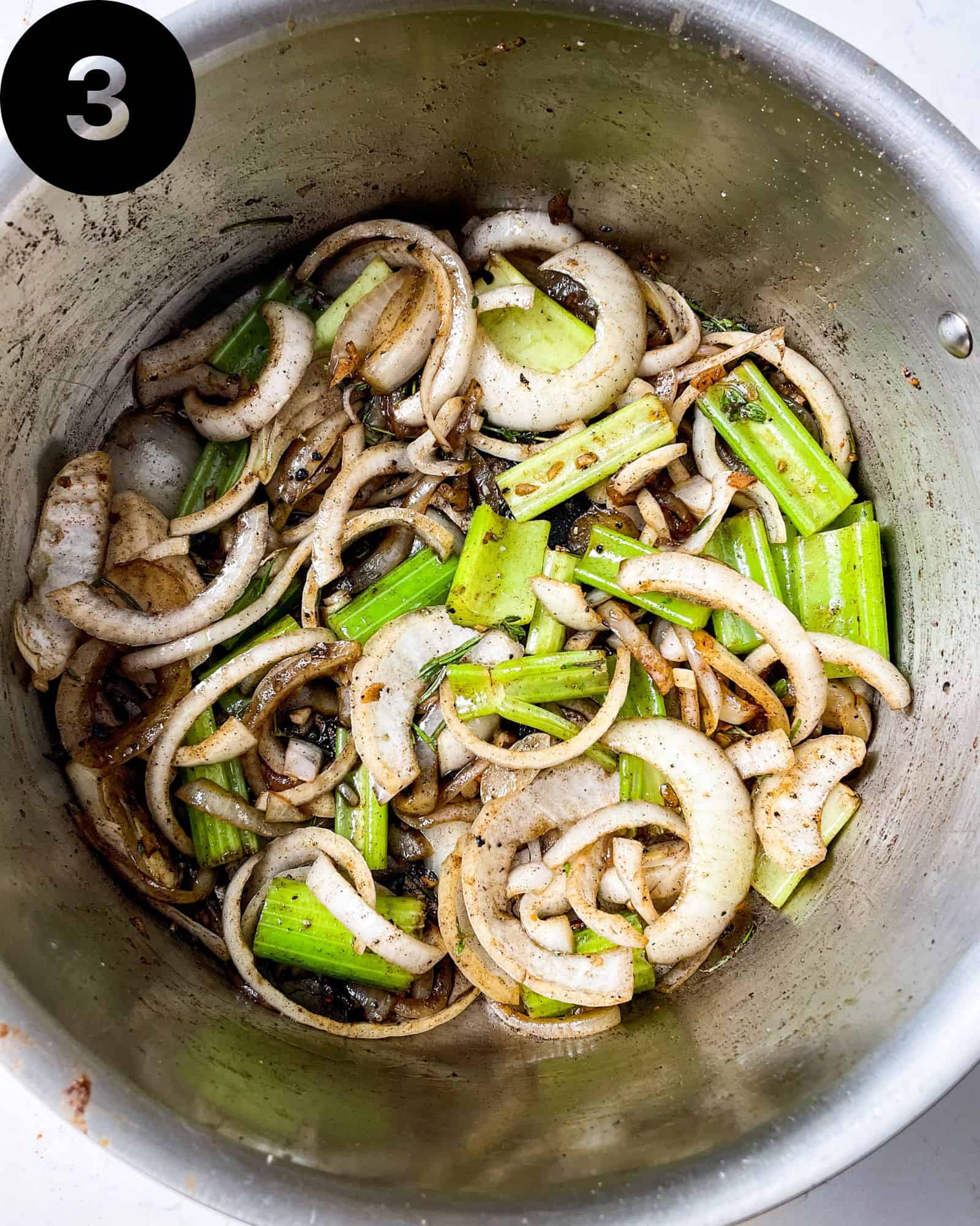celery, onions, garlic, and seasonings in a pan.