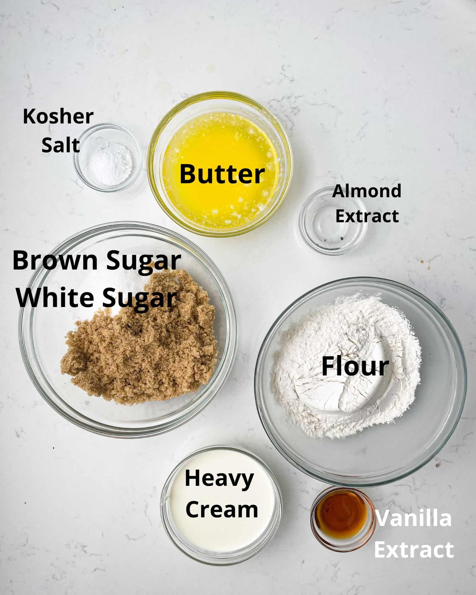 ingredients to make edible sugar cookie dough - butter, flour, brown sugar, white sugar, heavy cream, vanilla extract, almond extract, and kosher salt.