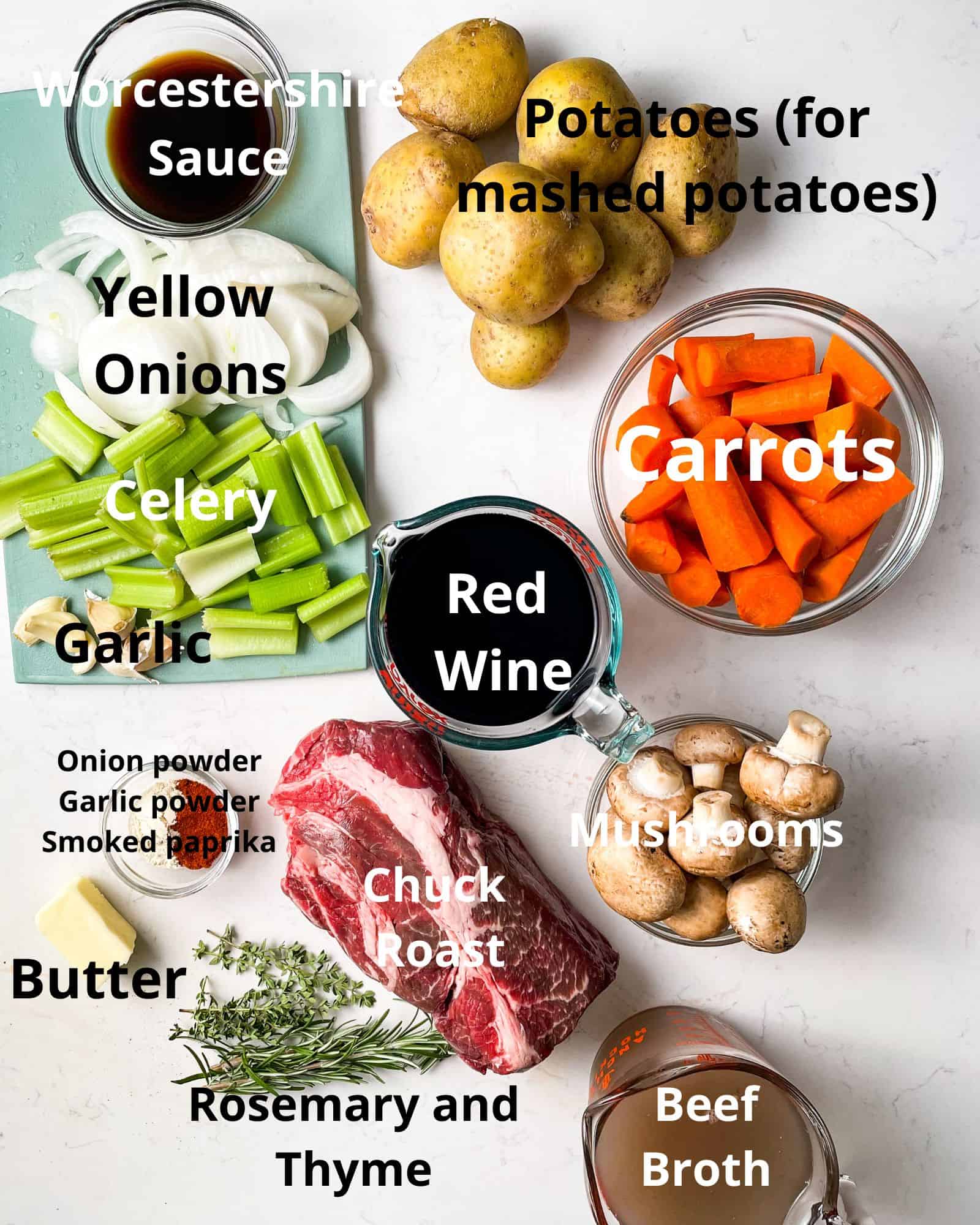 ingredients to make oven baked chuck roast - chuck roast, seasonings, onion, garlic, celery, carrots, fresh herbs, beef broth, red wine, Worcestershire sauce, and mushrooms.