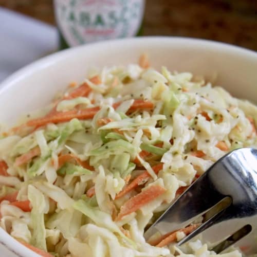 spicy coleslaw in a bowl with a fork.
