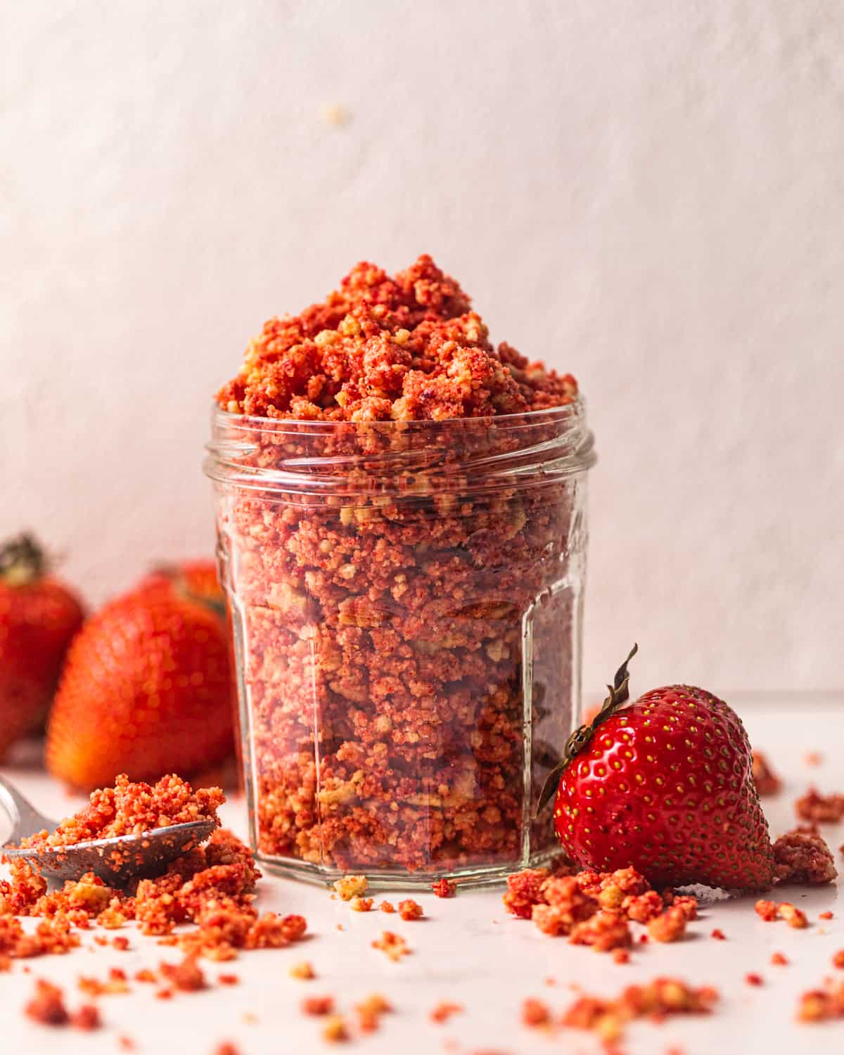 strawberry crumbles in a glass jar.