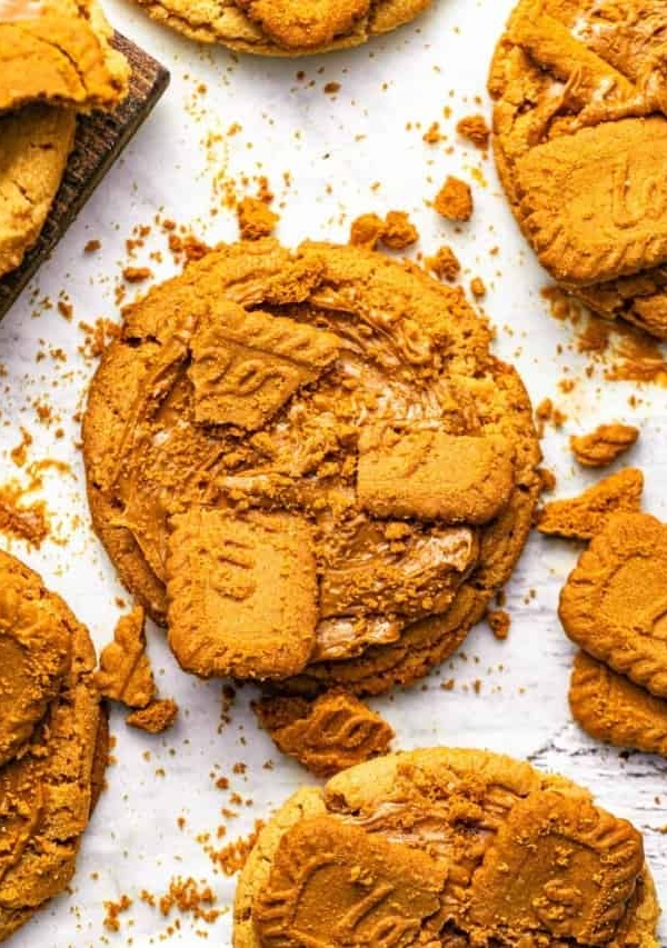biscoff butter cookies on a piece of parchment paper topped with biscoff and biscoff spread.