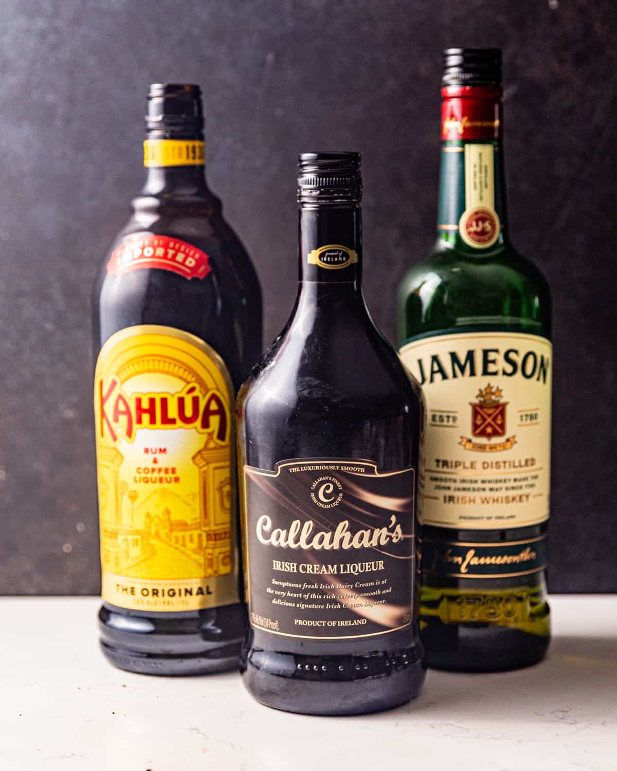ingredients to make a duck fart shot - kahlua coffee liqueur, baileys irish cream, and whiskey.