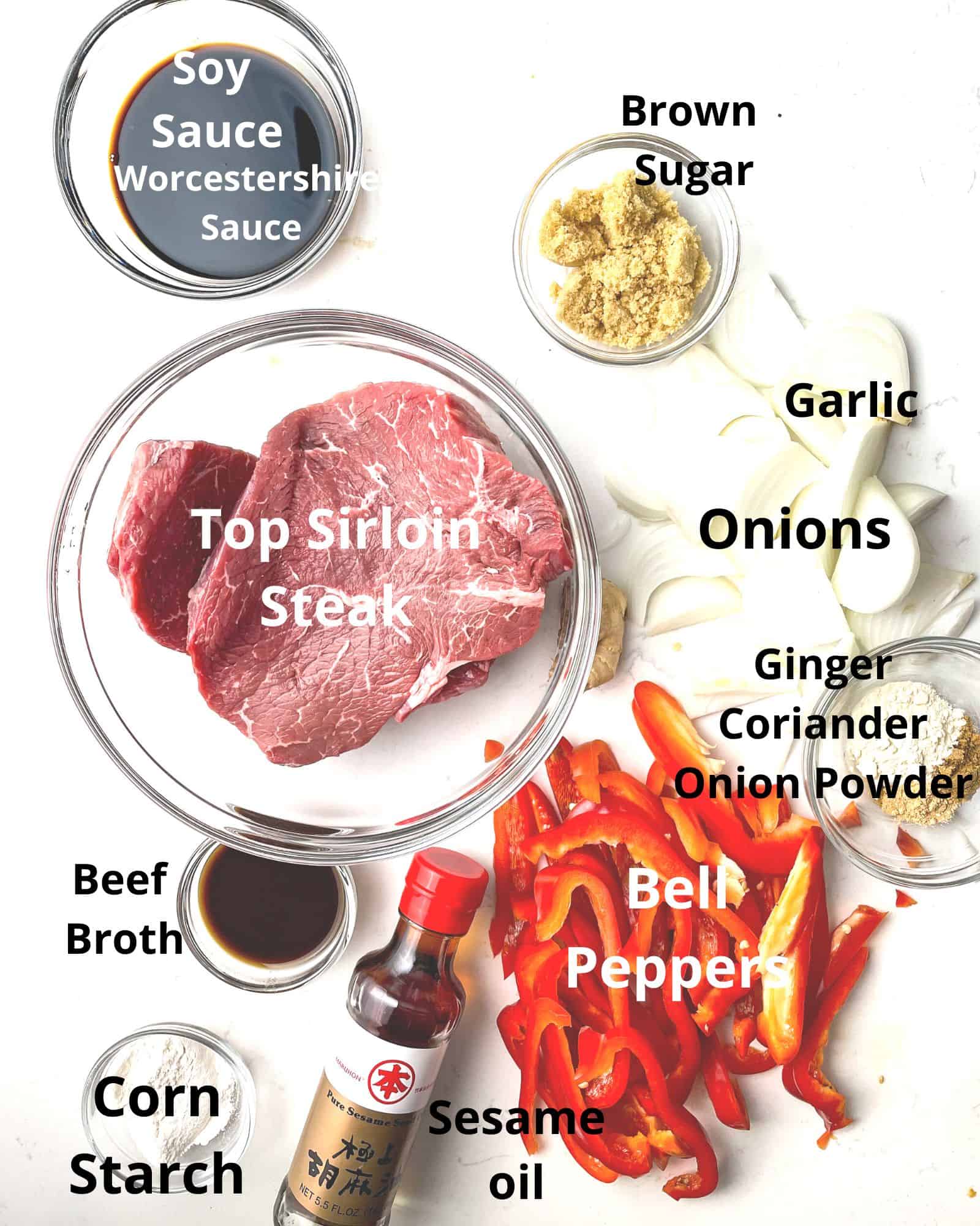 ingredients to make pepper steak - sirloin steak, soy sauce, onions, garlic, bell peppers, worcestershire sauce, brown sugar, sesame oil, corn starch, and beef broth.