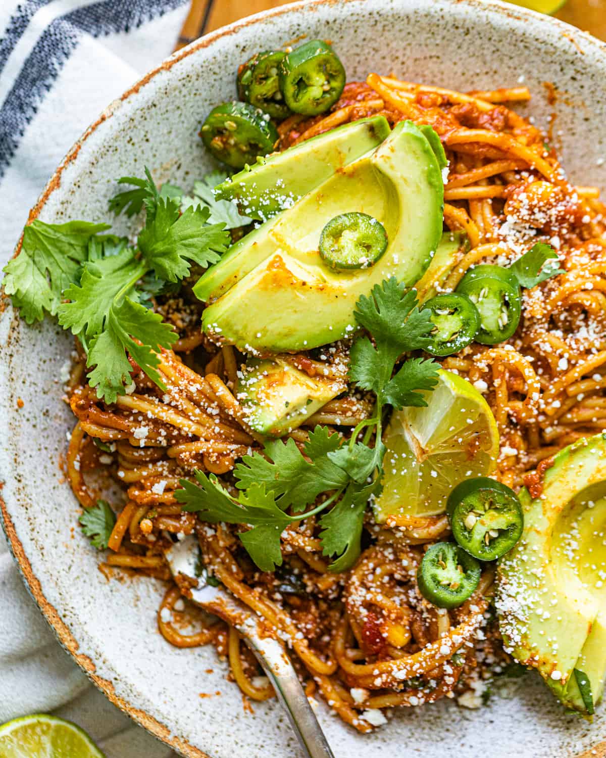 taco pasta on a plate with avocado.