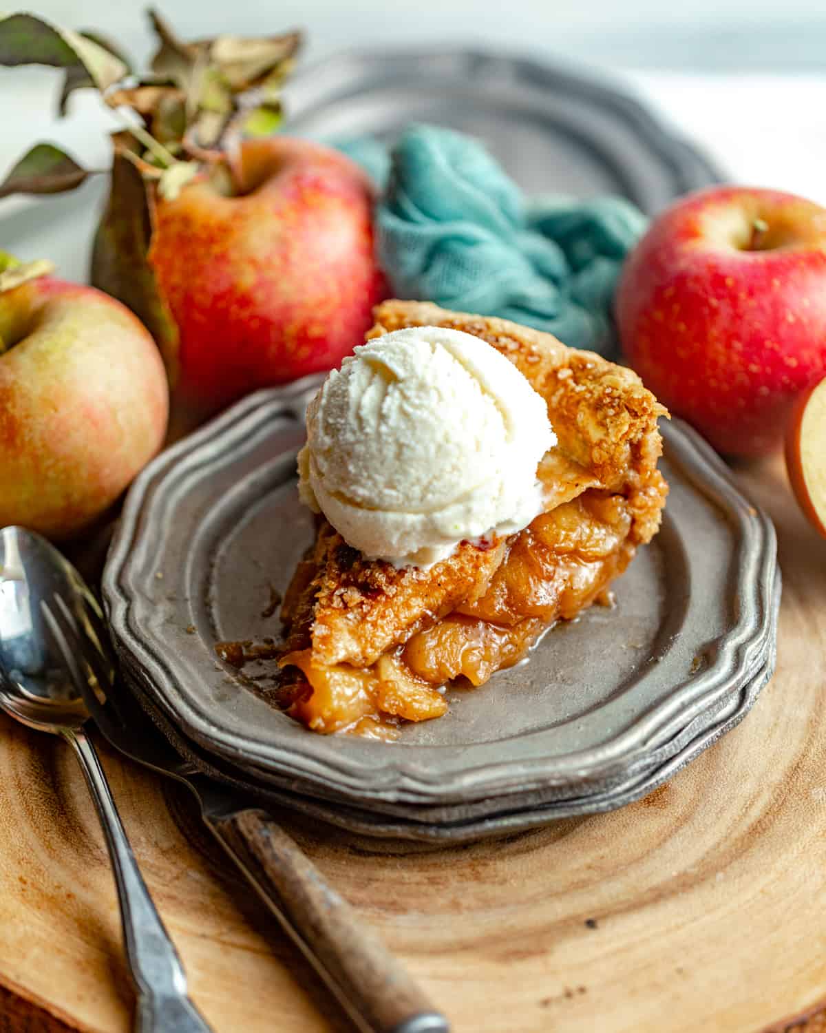 a slice of apple pie on a plate with ice cream.