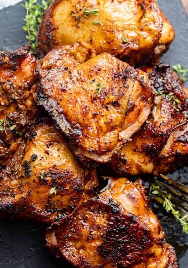 chicken thighs garnished with fresh herbs.