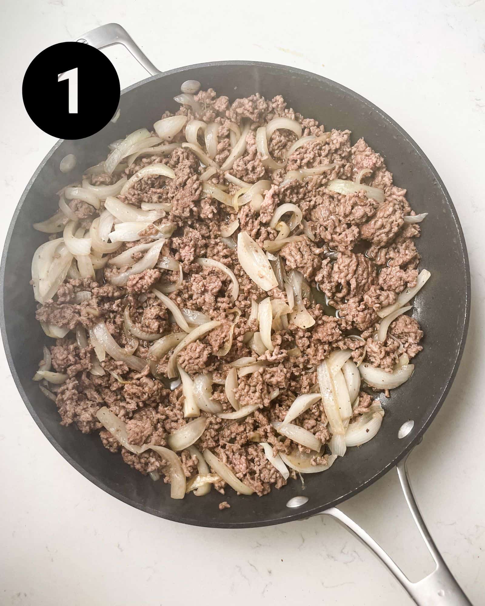 ground beef and onions in a skillet.