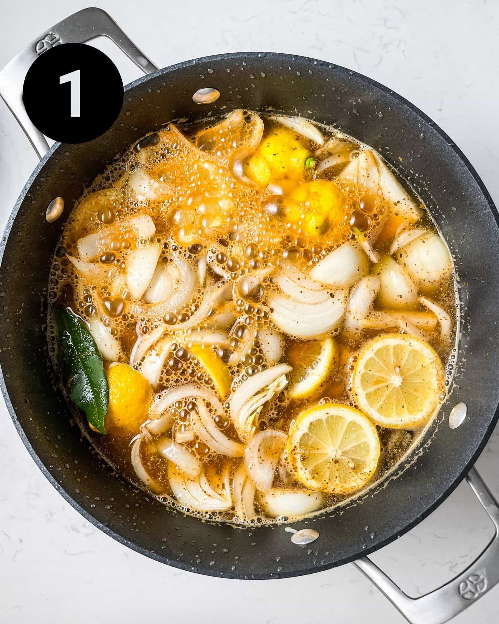 garlic, chicken broth, onions, lemons, bay leaves, and seasonings in a large pot.
