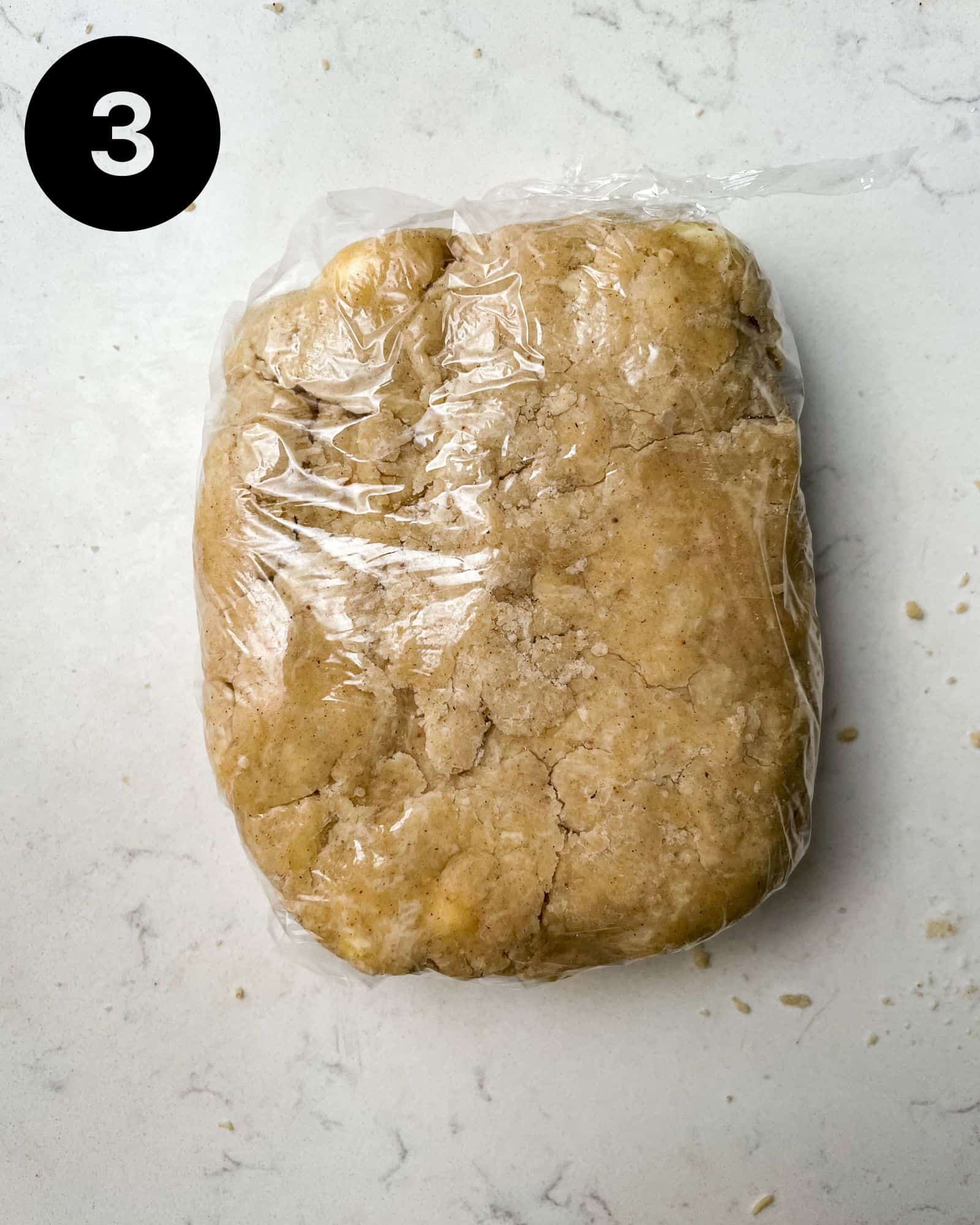 pie dough wrapped in plastic wrap.