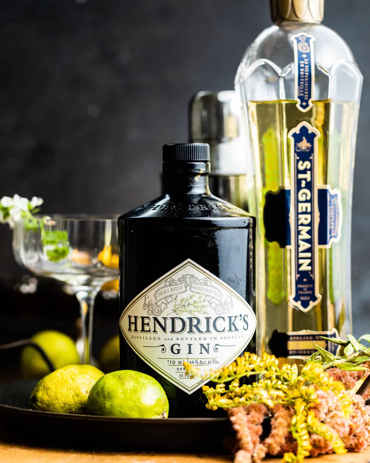ingredients to make a french gimlet - gin, elderflower liqueur, and lime juice.