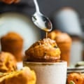 a pumpkin popover in a small bowl with butter on top.