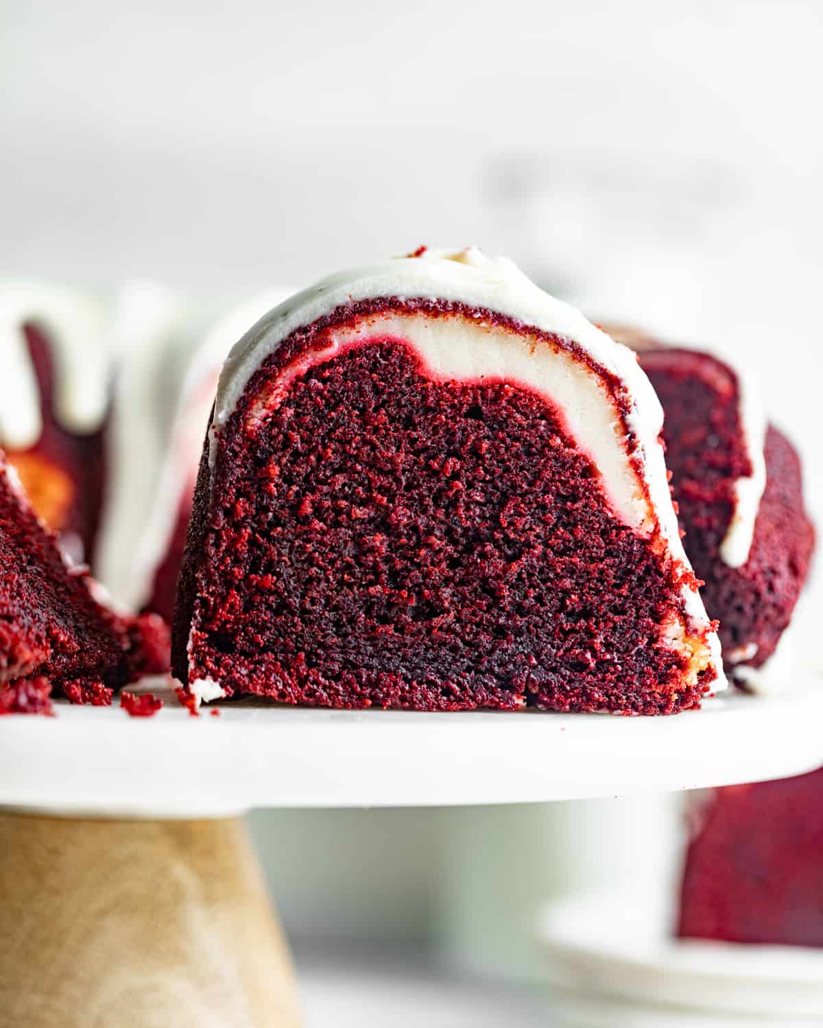 a slice of red velvet cake with a cream cheese swirl in the middle.