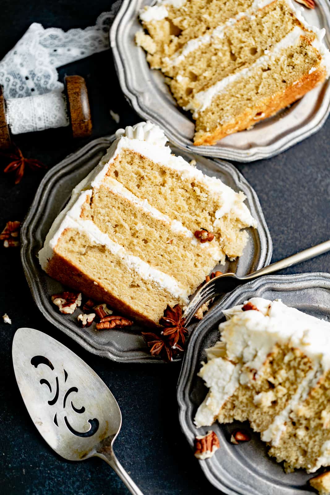 slices of cardamom cake on a plate with chopped pecans.