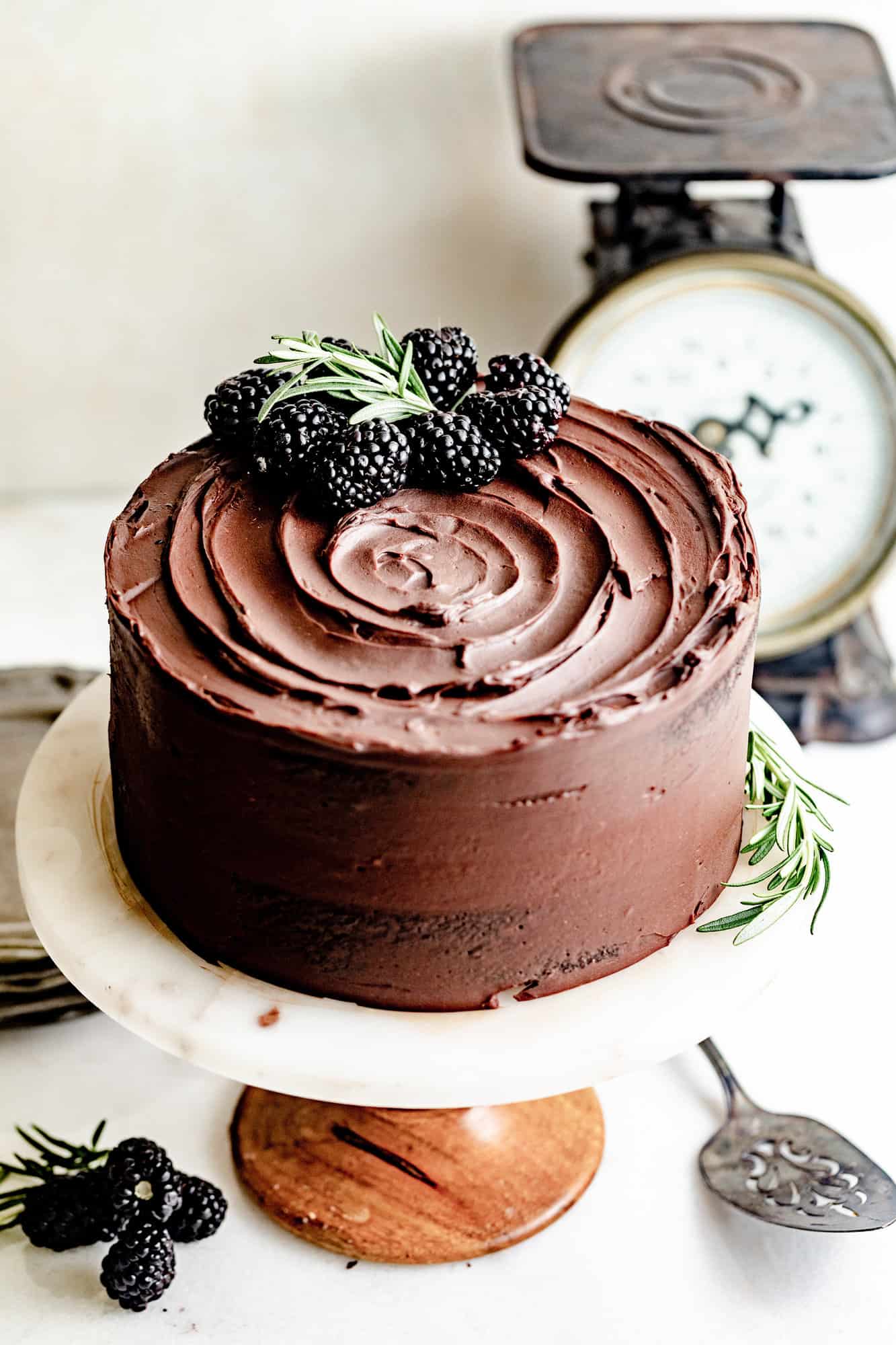 chocolate ganache cake on a cake stand.