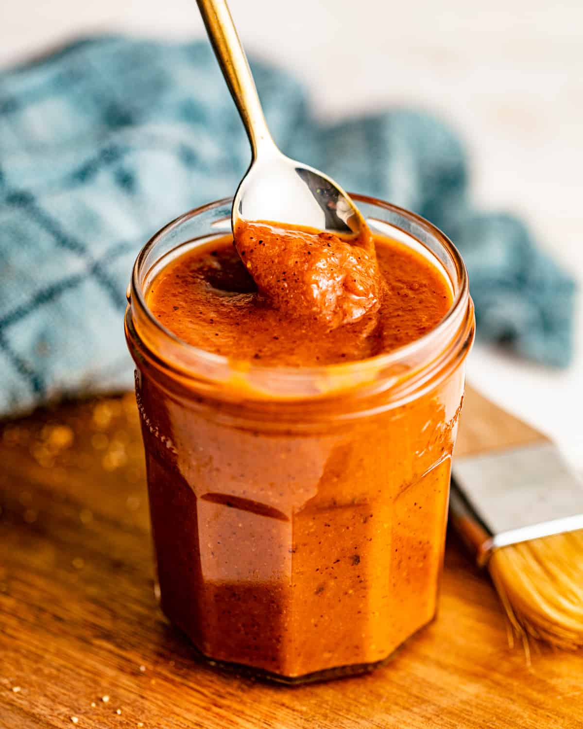 honey bbq sauce on a serving board with a spoon.