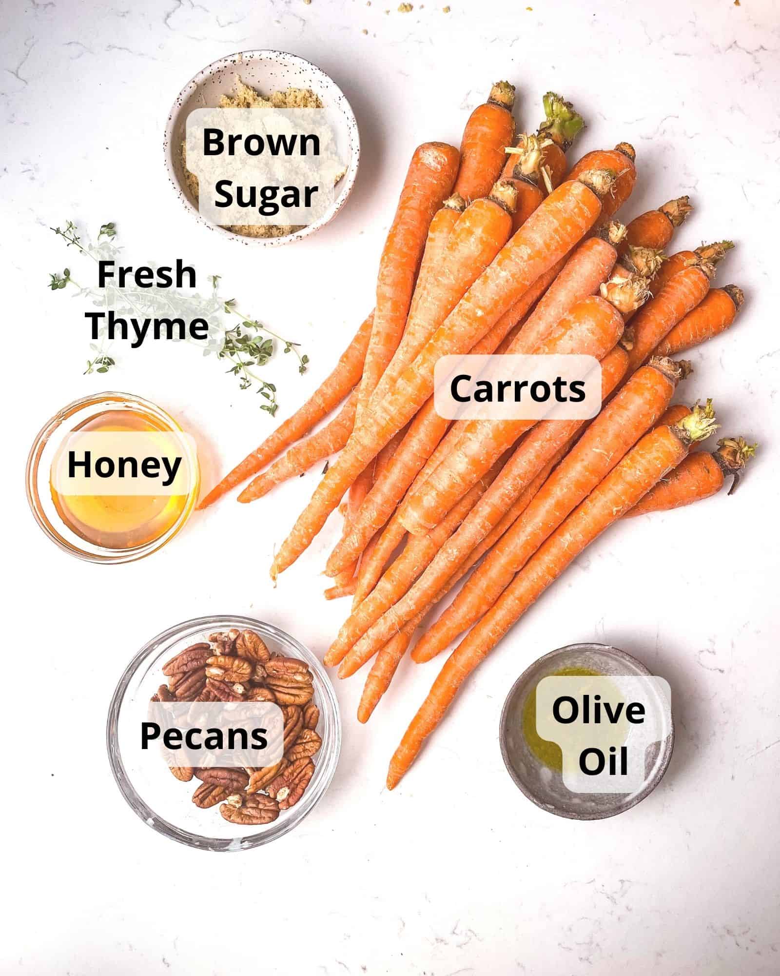 ingredients to make brown sugar honey glazed carrots - carrots, brown sugar, honey, olive oil, pecans, and fresh thyme.