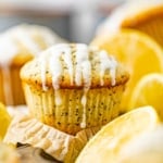 lemon poppy seed muffins next to sliced lemons.
