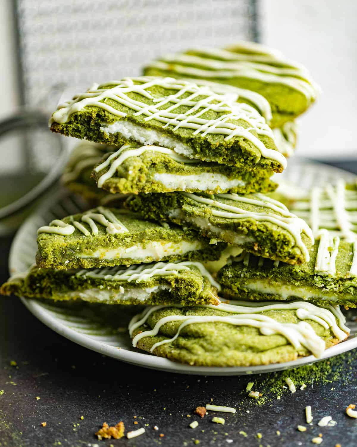 matcha cookies on a plate stacked on top of each other.