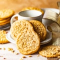 chewy peanut butter cookies on a plate with a mug.