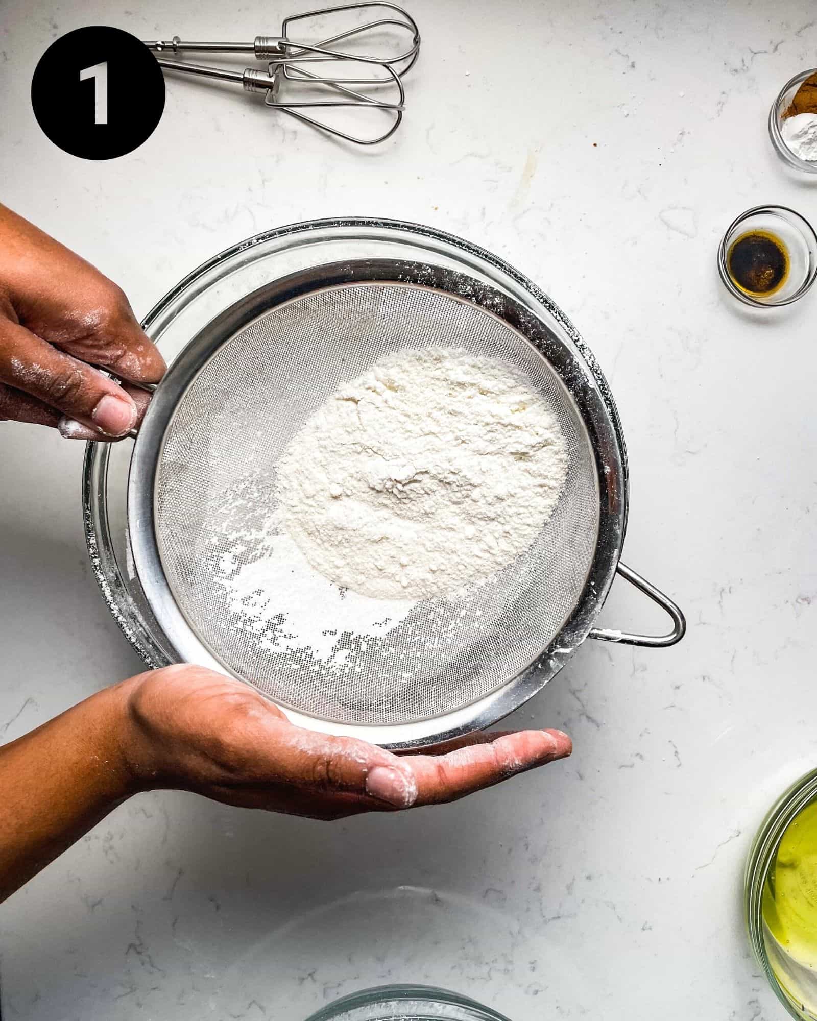 sifting almond flour into a bowl.