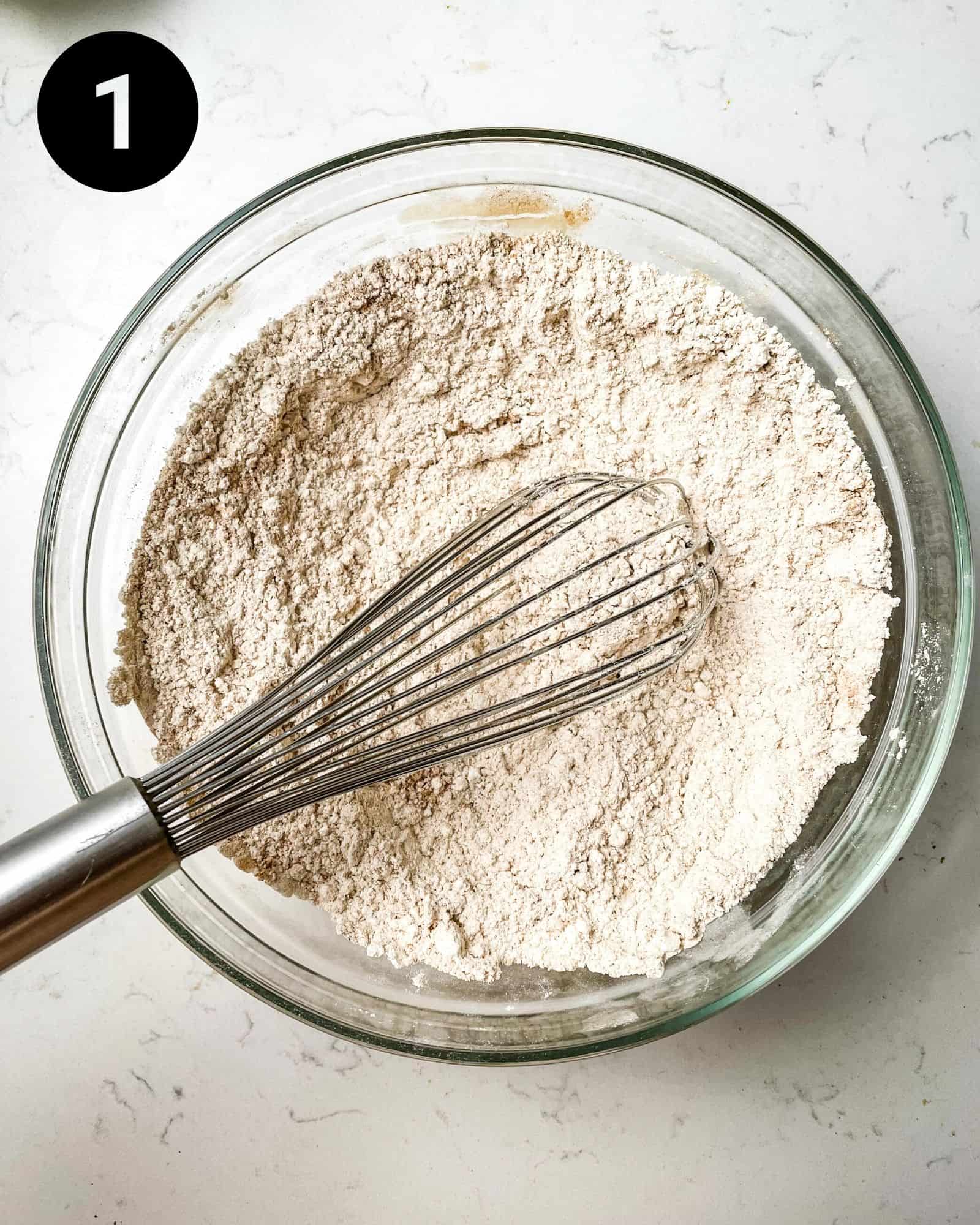 flour, spices, baking soda, and baking powder whisked together in a bowl.