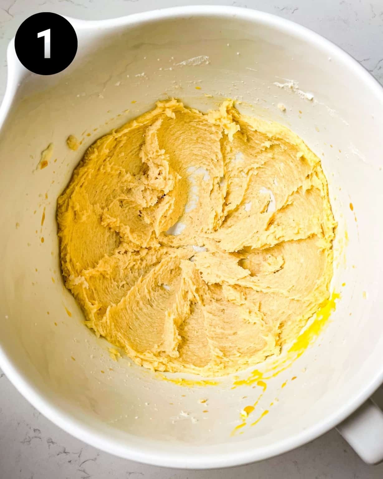 butter and sugar creamed together in a mixing bowl.
