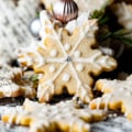 snowflake cookies scattered around on a table.