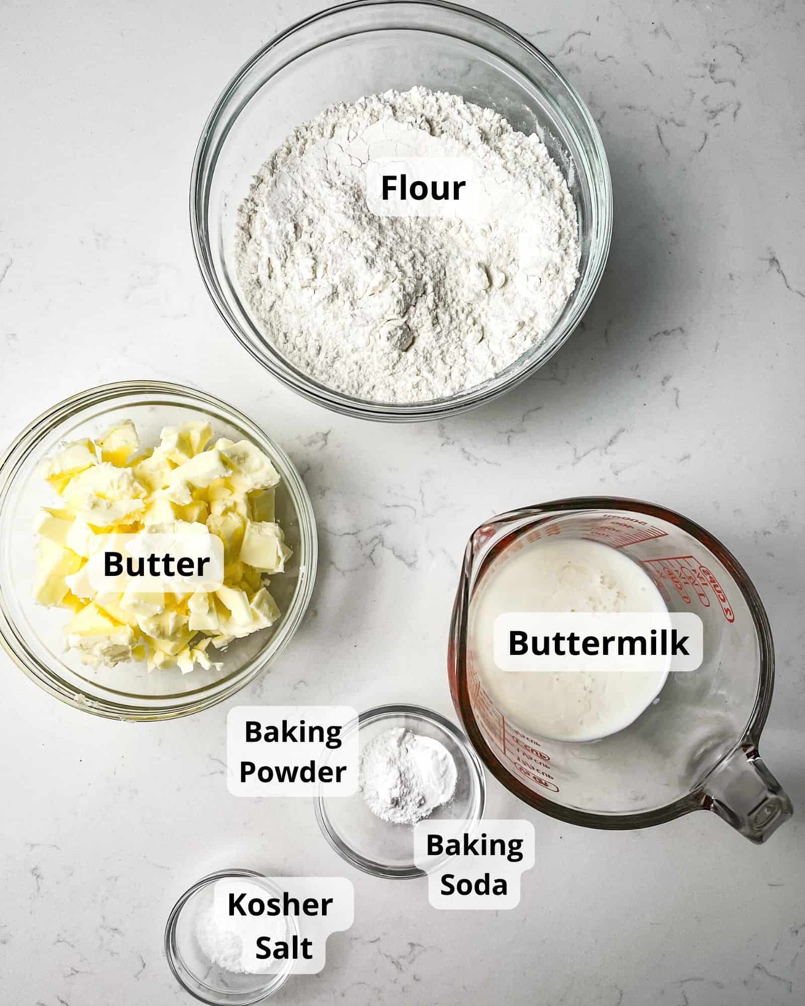 ingredients to make air fryer biscuits - flour, buttermilk, kosher salt, butter, baking powder, and baking soda.