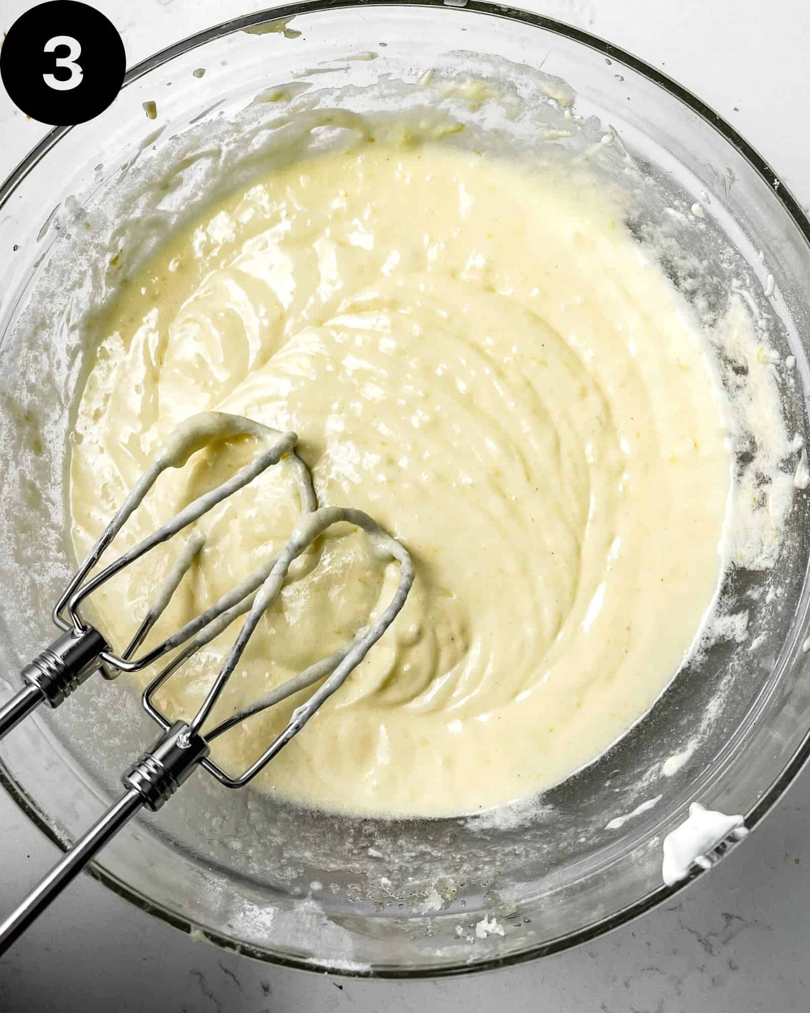 butter, sugar, oil, and eggs creamed together in a mixing bowl.