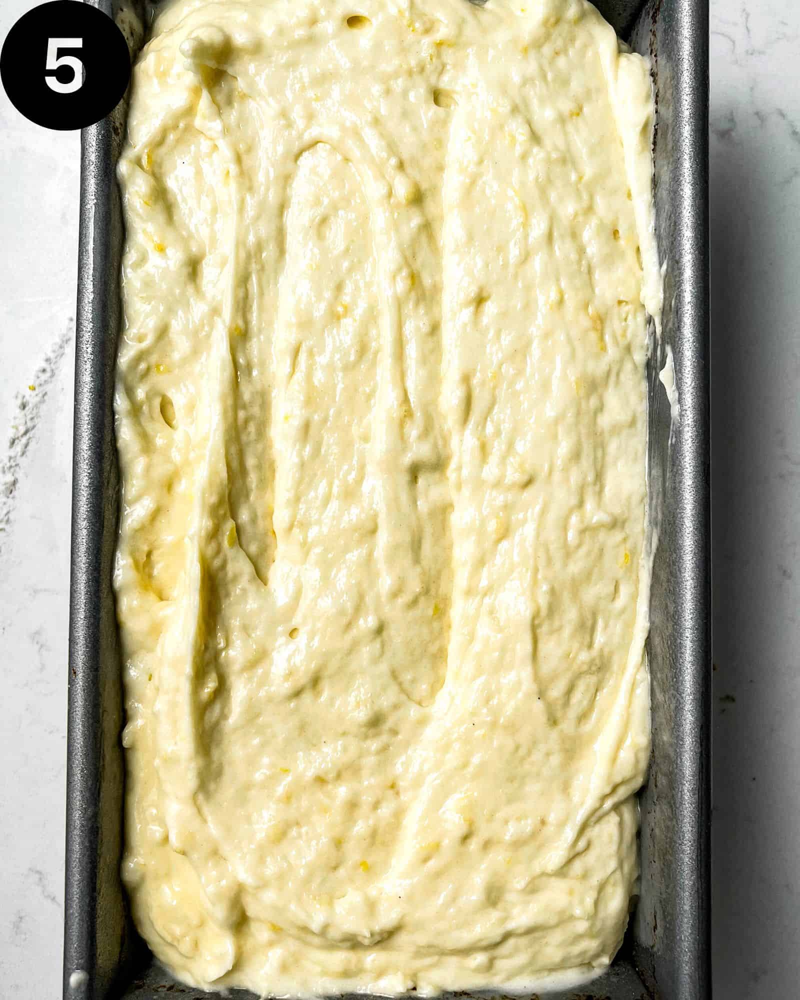 Lemon Loaf cake batter in a loaf pan.