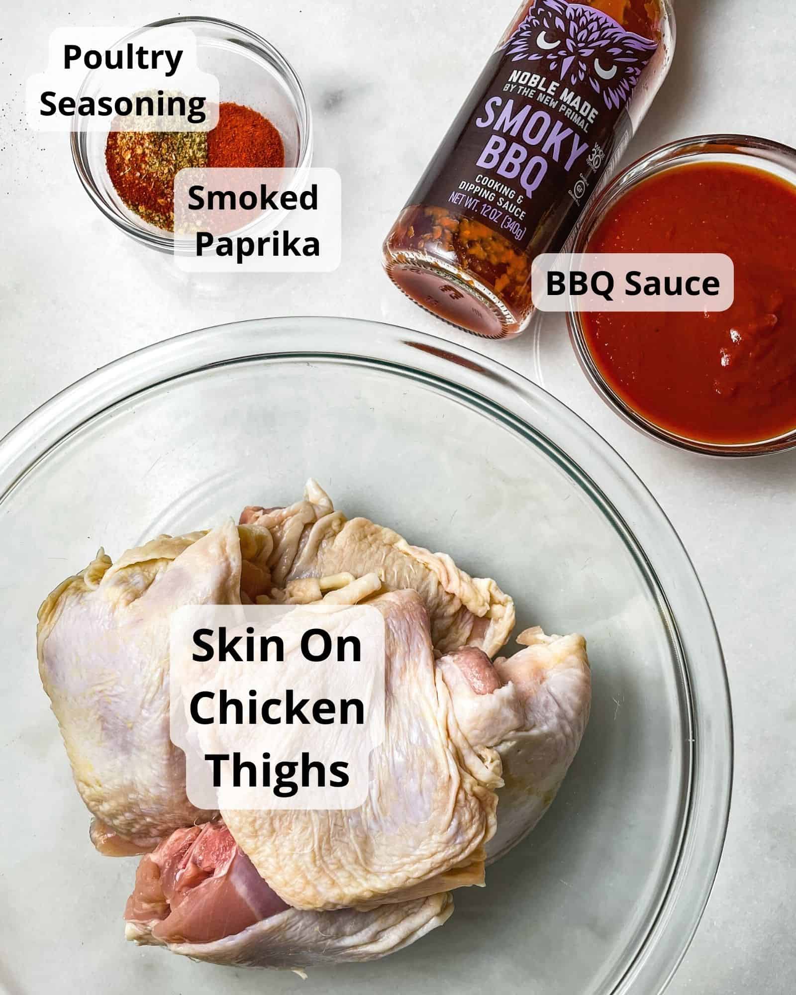 ingredients to make baked bbq chicken thighs - chicken thighs, bbq sauce, poultry seasoning, and smoked paprika.
